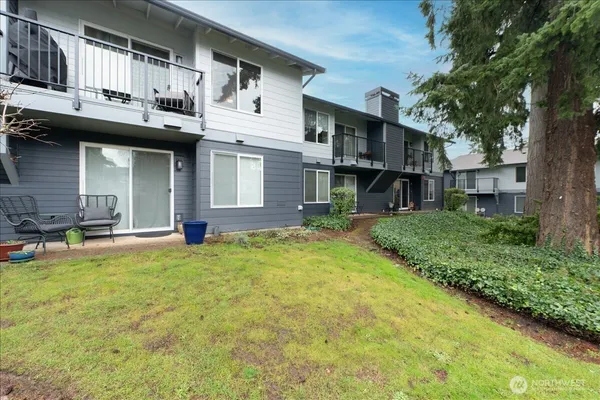 a view of a house with a patio and a yard