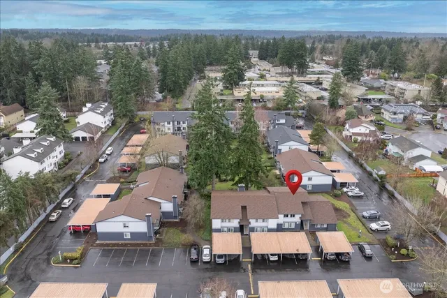 an aerial view of a houses with a yard