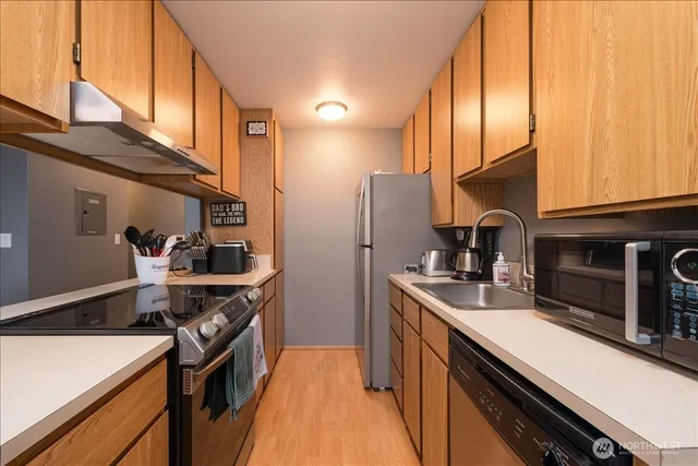 a kitchen with stainless steel appliances granite countertop a sink stove and refrigerator