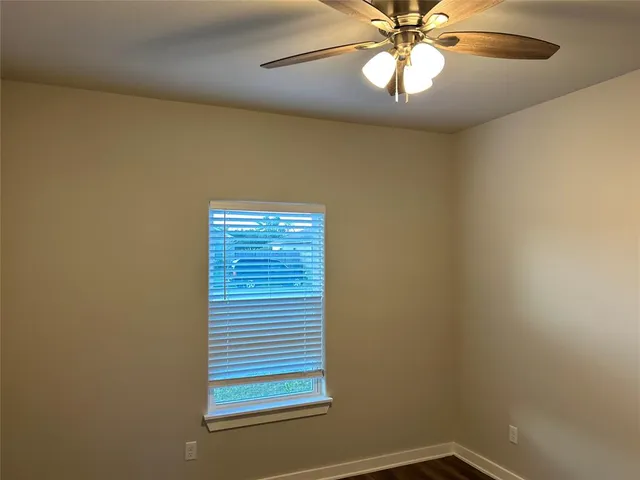 a view of a hallway with wooden floor and closet area