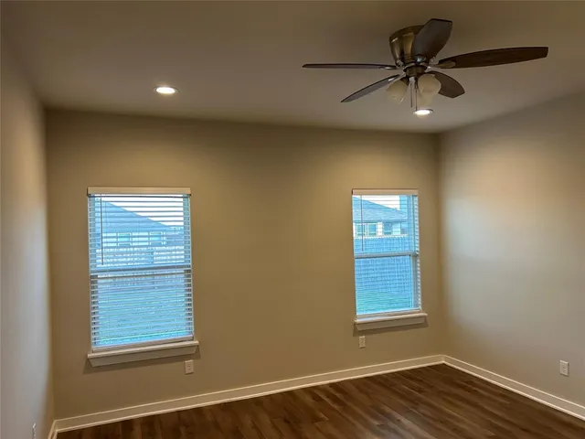 a open kitchen with stainless steel appliances granite countertop a refrigerator a sink dishwasher a stove and a microwave oven on the wooden floor