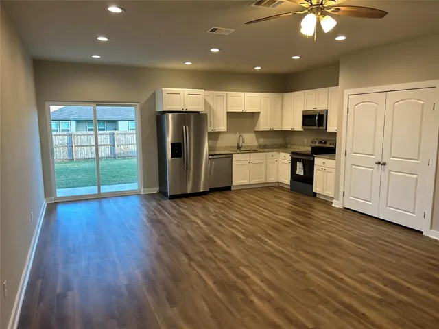 a kitchen with kitchen island microwave and cabinets