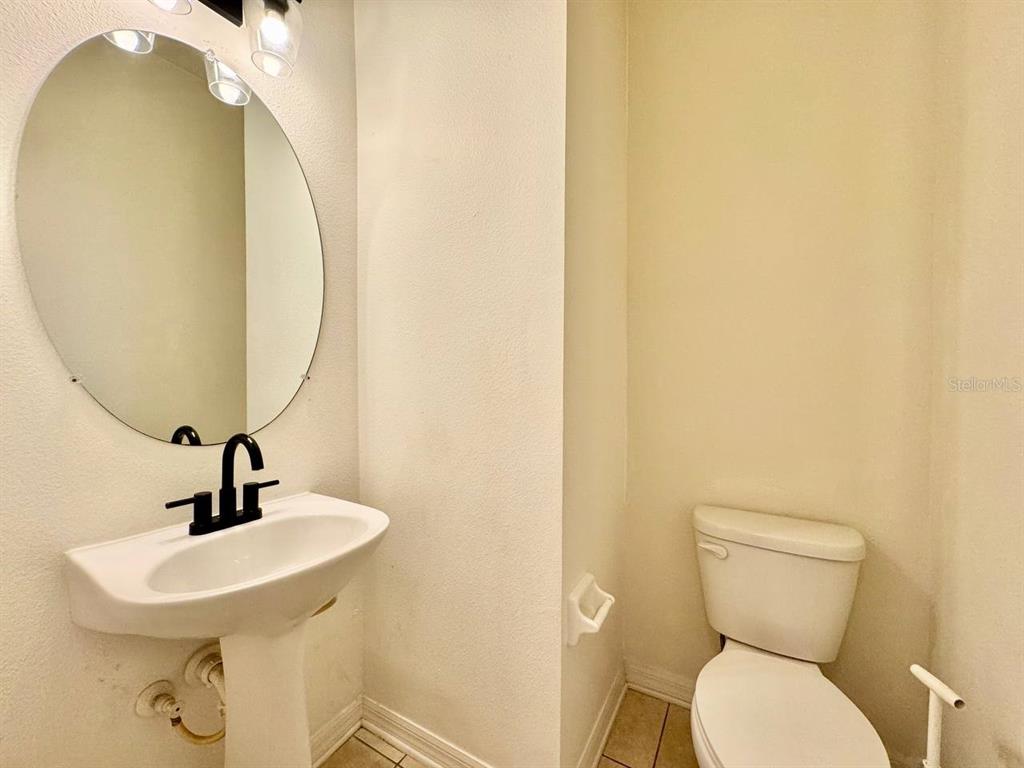 10545 Shady Falls Court Riverview, FL 33578 - Photo 13 of 36 a bathroom with a toilet sink and mirror