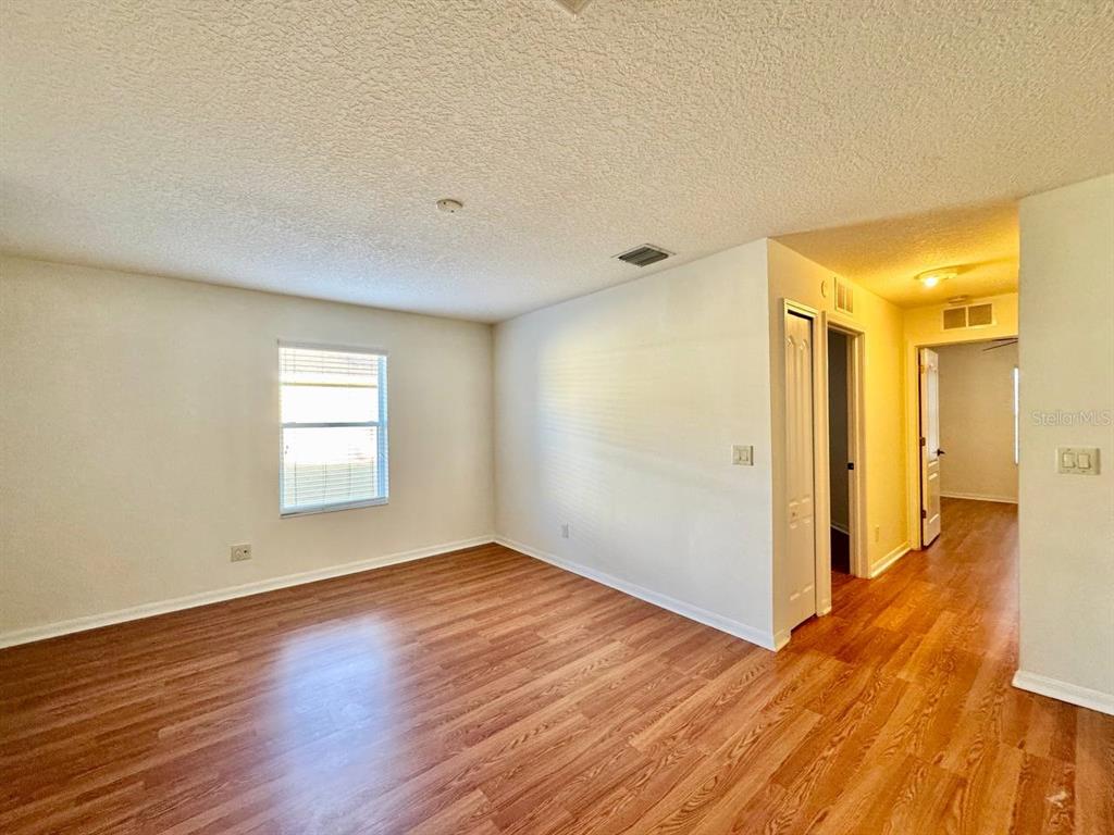 10545 Shady Falls Court Riverview, FL 33578 - Photo 14 of 36 an empty room with wooden floor and windows
