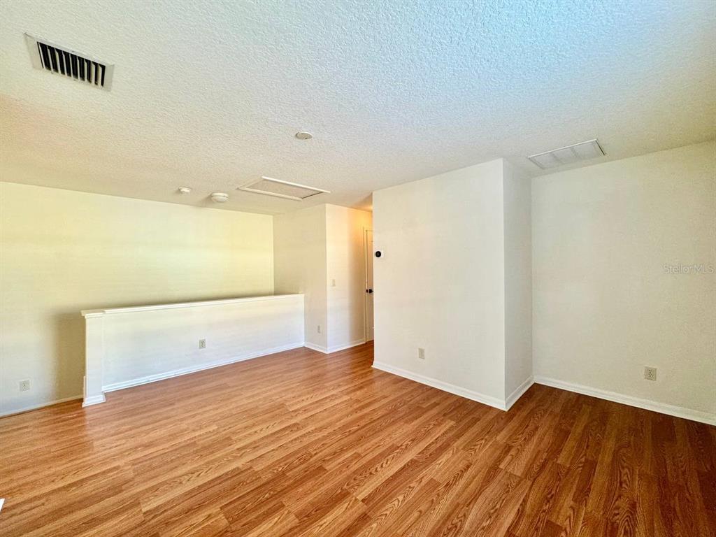 10545 Shady Falls Court Riverview, FL 33578 - Photo 16 of 36 a view of an empty room with wooden floor