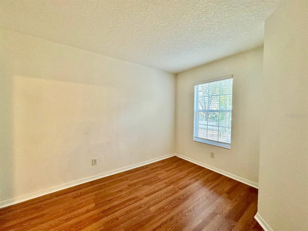 10545 Shady Falls Court Riverview, FL 33578 - Photo 18 of 36 an empty room with wooden floor and windows