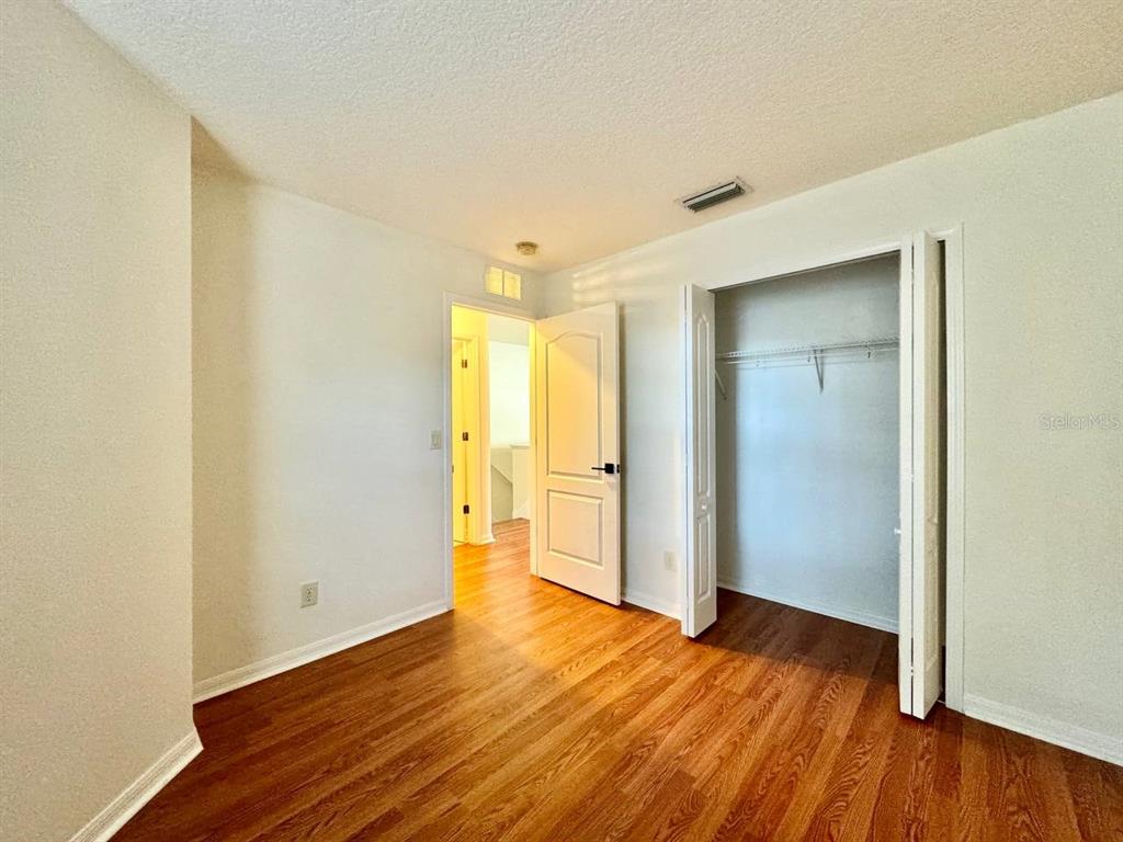10545 Shady Falls Court Riverview, FL 33578 - Photo 19 of 36 a view of an empty room with wooden floor and closet