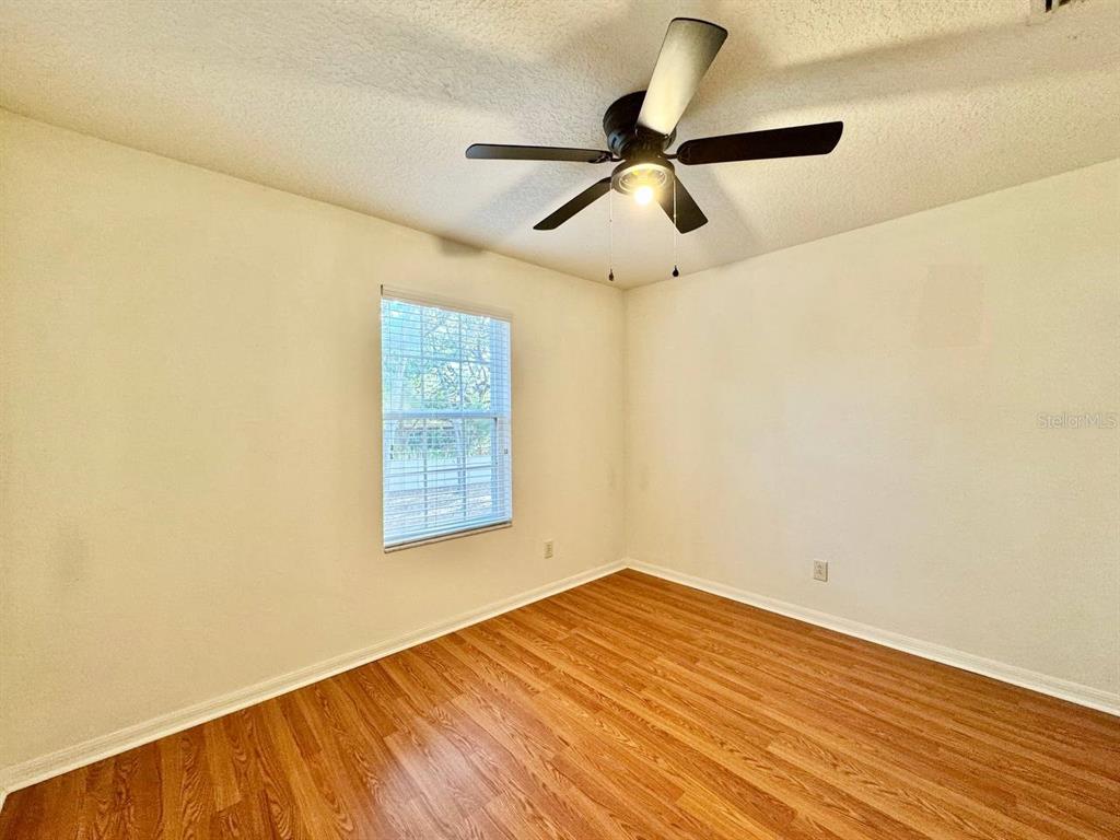 10545 Shady Falls Court Riverview, FL 33578 - Photo 21 of 36 a view of empty room with wooden floor and fan