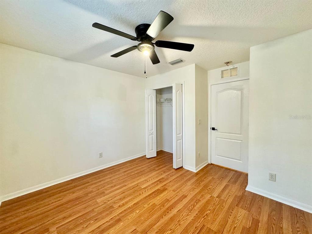 10545 Shady Falls Court Riverview, FL 33578 - Photo 22 of 36 a view of a livingroom with wooden floor and a ceiling fan