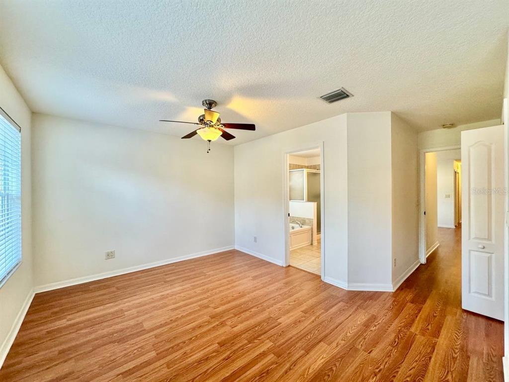 10545 Shady Falls Court Riverview, FL 33578 - Photo 23 of 36 a view of a livingroom with wooden floor and a ceiling fan