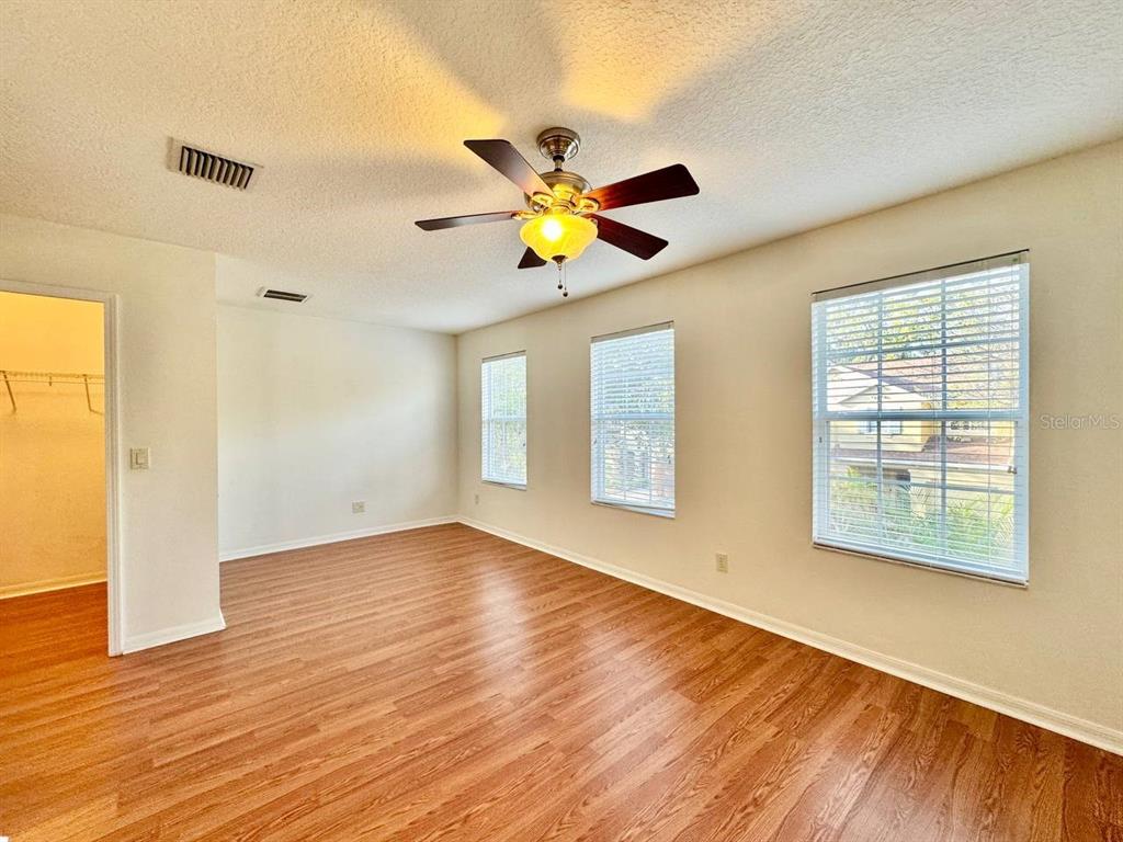 10545 Shady Falls Court Riverview, FL 33578 - Photo 25 of 36 a view of an empty room with window and wooden floor