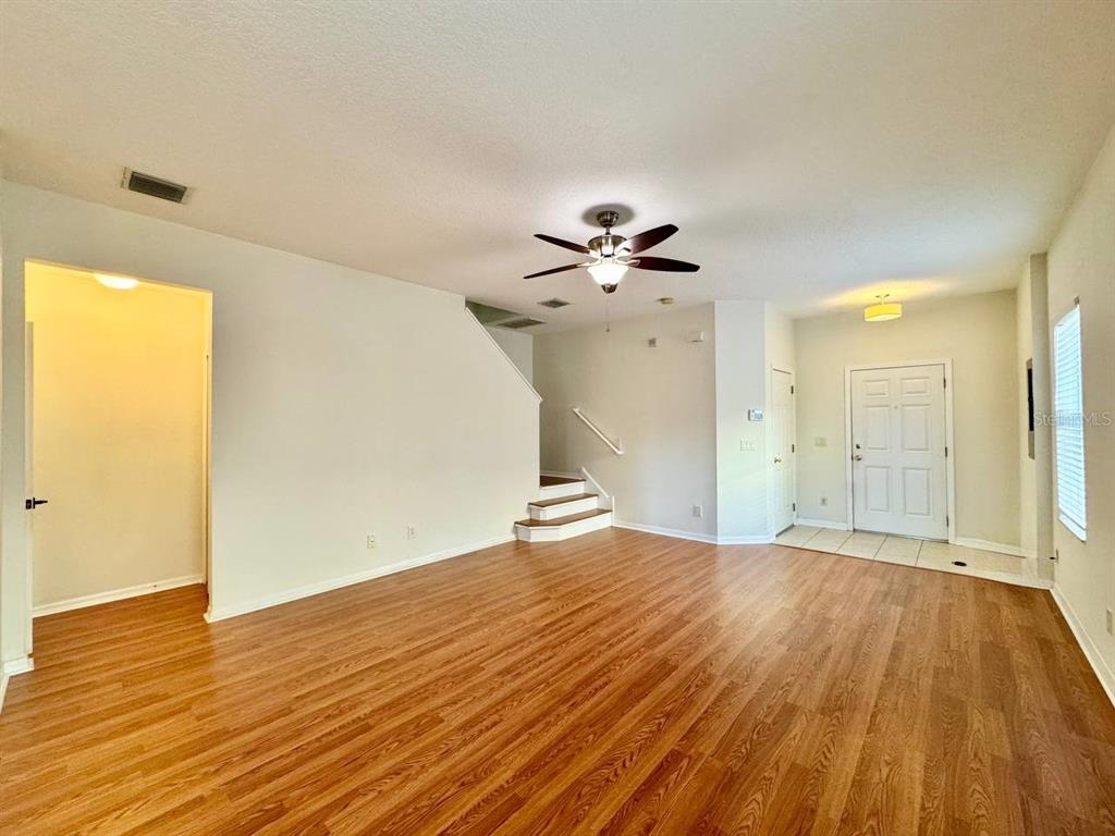 10545 Shady Falls Court Riverview, FL 33578 - Photo 5 of 36 a view of empty room with wooden floor and fan