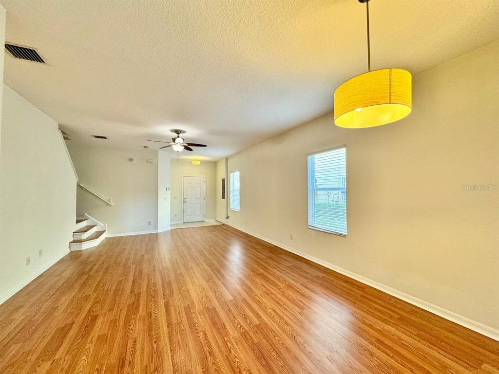 10545 Shady Falls Court Riverview, FL 33578 - Photo 7 of 36 a view of an empty room with wooden floor and a window