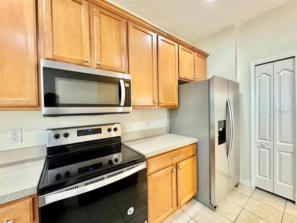 a kitchen with stainless steel appliances a stove a microwave and a refrigerator