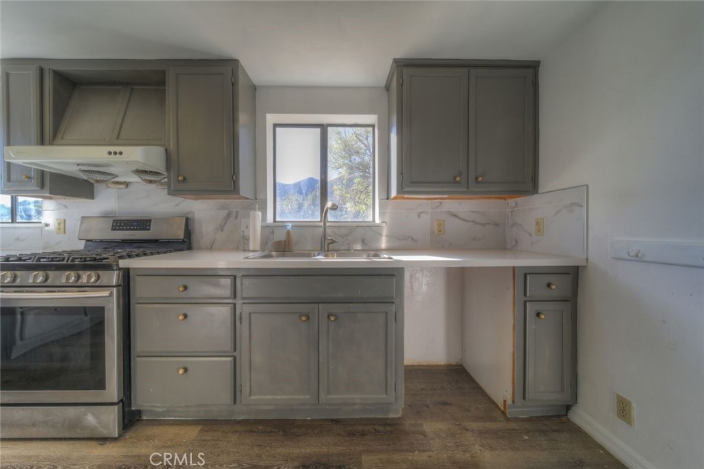 51201 Deer Mountain Way Anza, CA 92539 - Photo 12 of 65 a kitchen with sink cabinets and window
