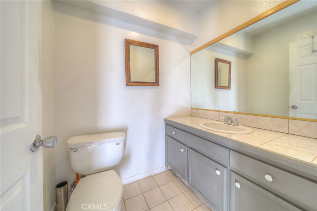 51201 Deer Mountain Way Anza, CA 92539 - Photo 21 of 65 a bathroom with a toilet sink and mirror