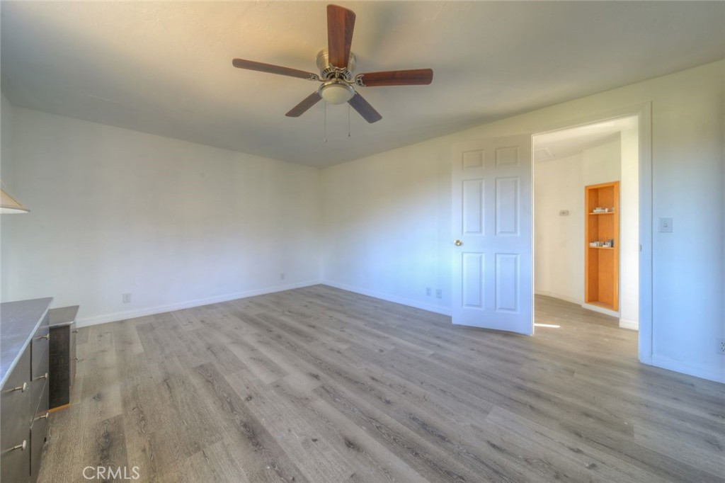 51201 Deer Mountain Way Anza, CA 92539 - Photo 34 of 65 an empty room with wooden floor fan and windows