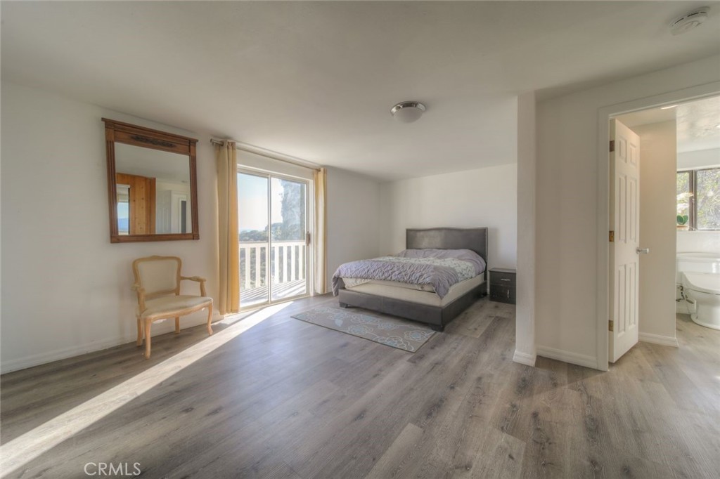 51201 Deer Mountain Way Anza, CA 92539 - Photo 36 of 65 a bedroom with a bed and a couch