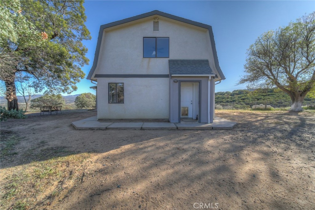 51201 Deer Mountain Way Anza, CA 92539 - Photo 6 of 65 a front view of a house with a yard