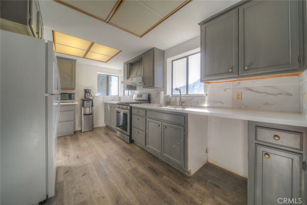 51201 Deer Mountain Way Anza, CA 92539 - Photo 9 of 65 a kitchen with stainless steel appliances granite countertop a sink a stove and refrigerator