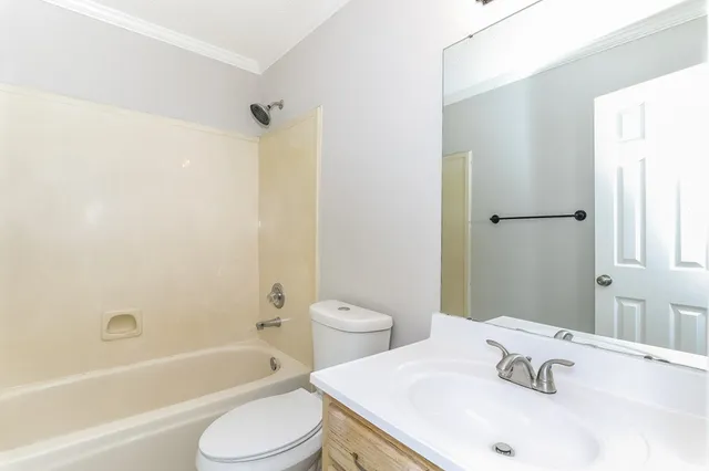 front view of a house with a large tree