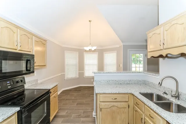 a kitchen with a sink a cabinets and window