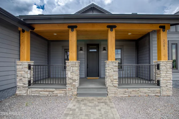 a view of empty room with wooden floor and floor to ceiling window