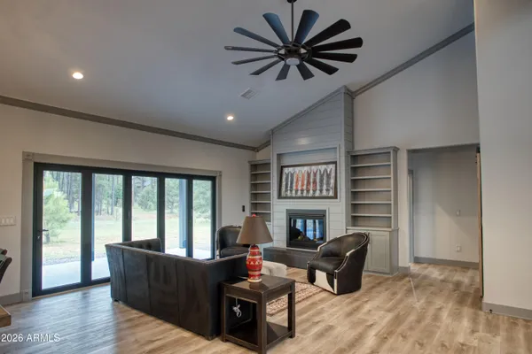 a living room with furniture a fireplace and a flat screen tv