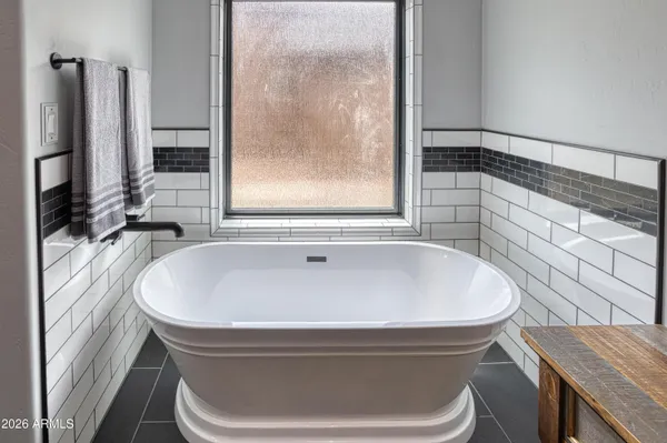a bath tub sitting in a bathroom next to a window