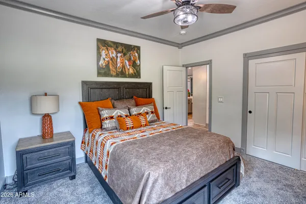 a bedroom with a bed and a chandelier