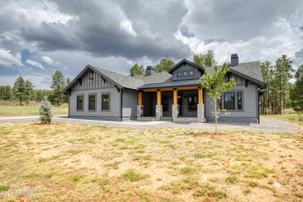 a spacious bedroom with a bed dresser and a window
