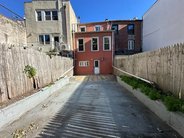 a view of a brick building next to a yard