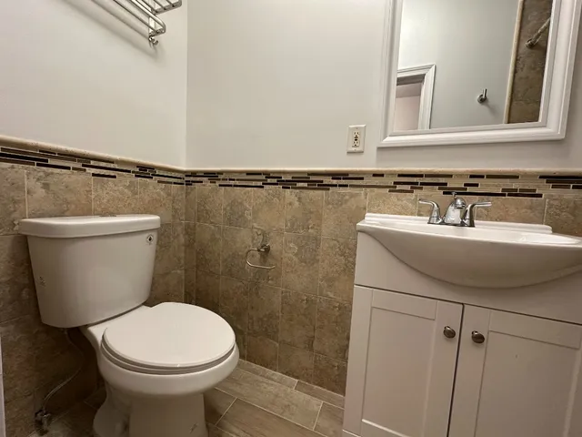 a bathroom with a sink a toilet and a mirror