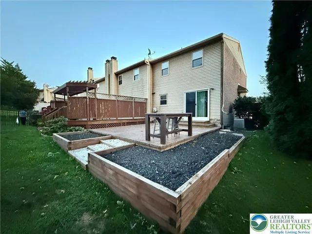 a view of a house with backyard tub and chairs