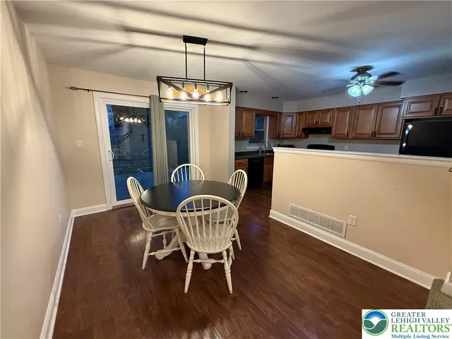 a view of a dining room with furniture wooden floor and chandelier