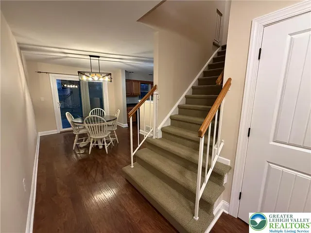 a view of entryway and hall with wooden floor