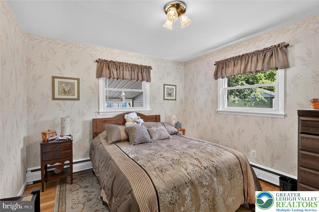 740 Public Road Bethlehem, PA 18015 - Photo 23 of 40 Well-lit sleeping quarters with natural light streaming through two windows, creating an inviting space.