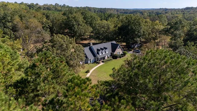 an aerial view of a house with a yard