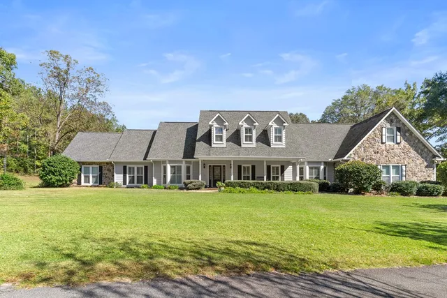 a front view of a house with garden