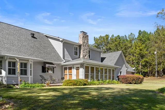 a front view of a house with a garden