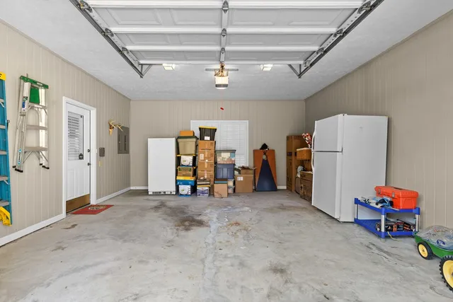 a bed room with a bed mirror and a chandelier