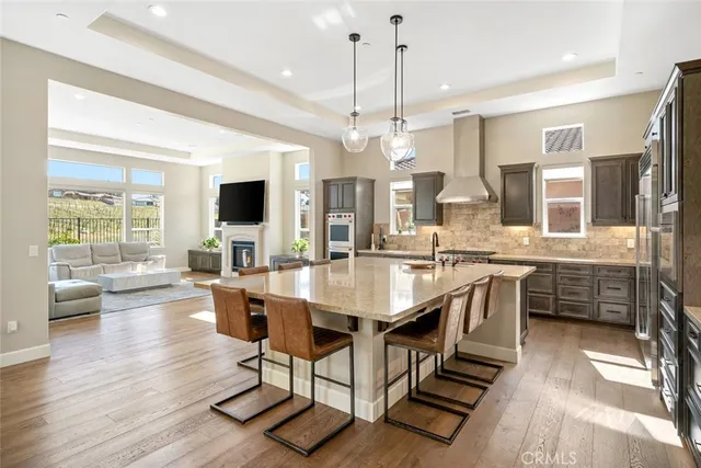 a living room with furniture or kitchen view and a wooden floor