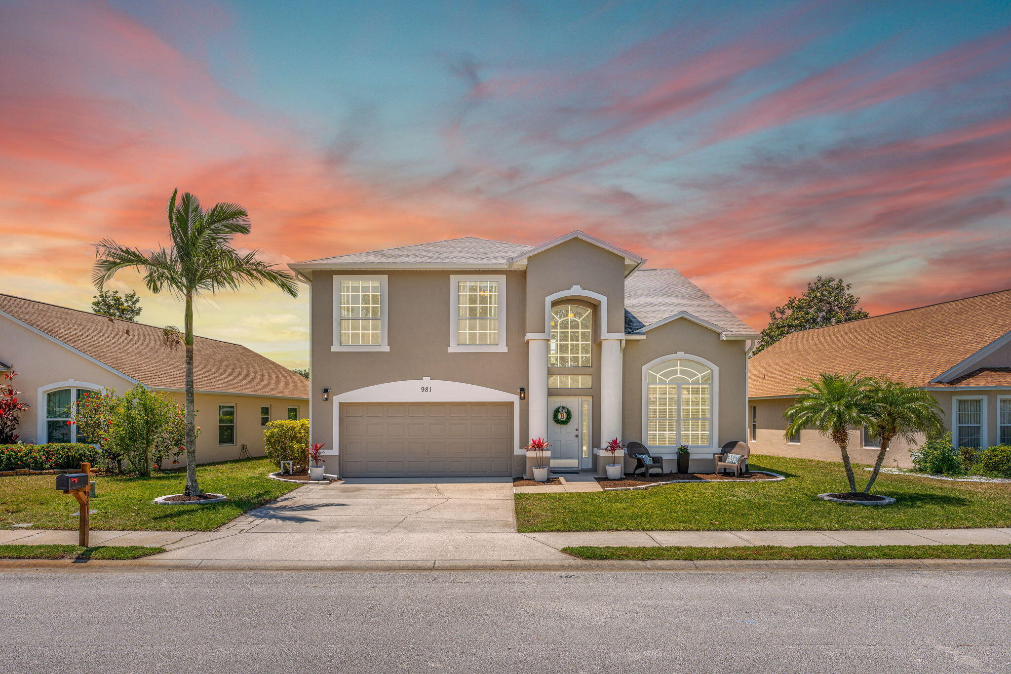 981 Shaw Circle Melbourne, FL 32940 - Photo 1 of 58 a front view of a house with a garden and plants