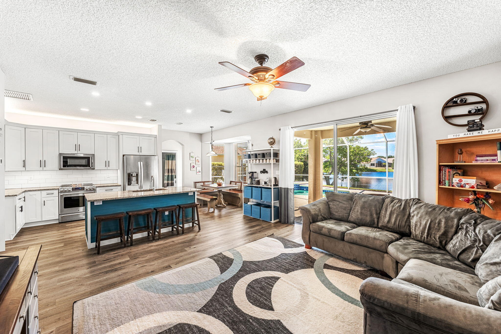 981 Shaw Circle Melbourne, FL 32940 - Photo 17 of 58 a living room with furniture kitchen view and a large window