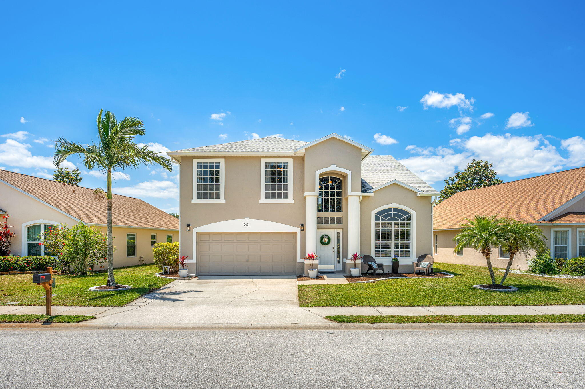 981 Shaw Circle Melbourne, FL 32940 - Photo 2 of 58 a front view of a house with a yard and garage