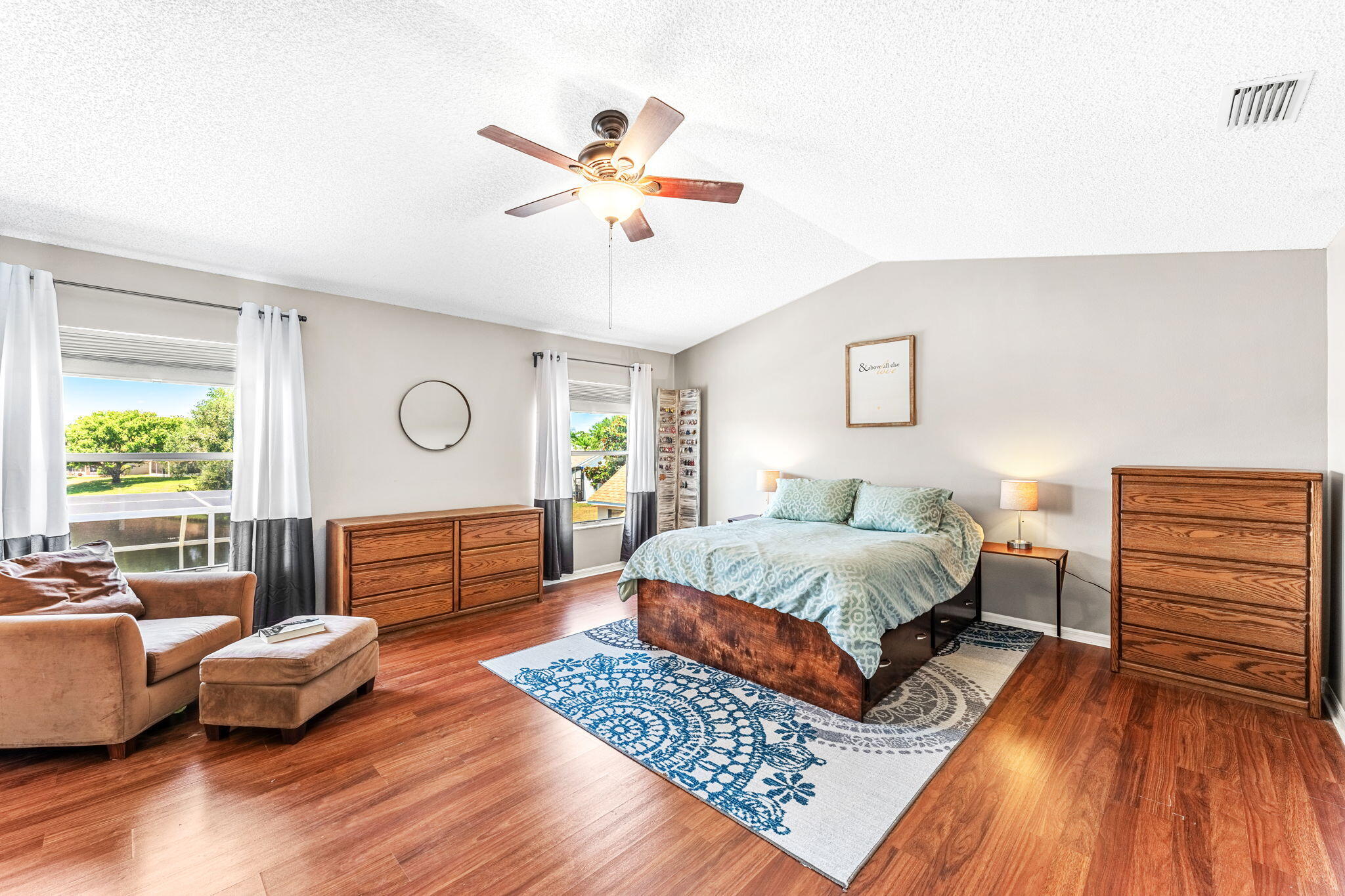 981 Shaw Circle Melbourne, FL 32940 - Photo 32 of 58 a spacious bedroom with a bed and wooden floor