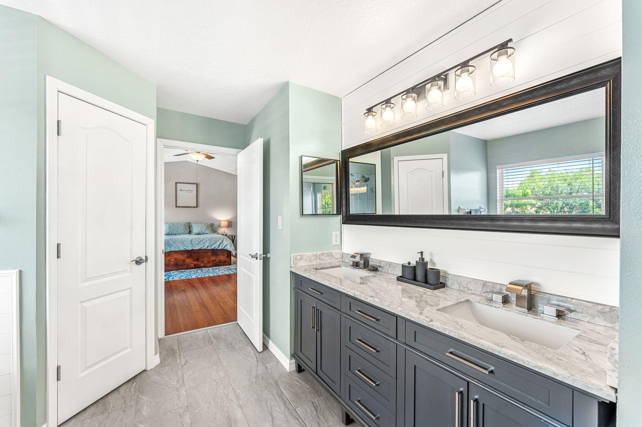 981 Shaw Circle Melbourne, FL 32940 - Photo 37 of 58 a spacious bathroom with a granite countertop sink mirror and bathtub