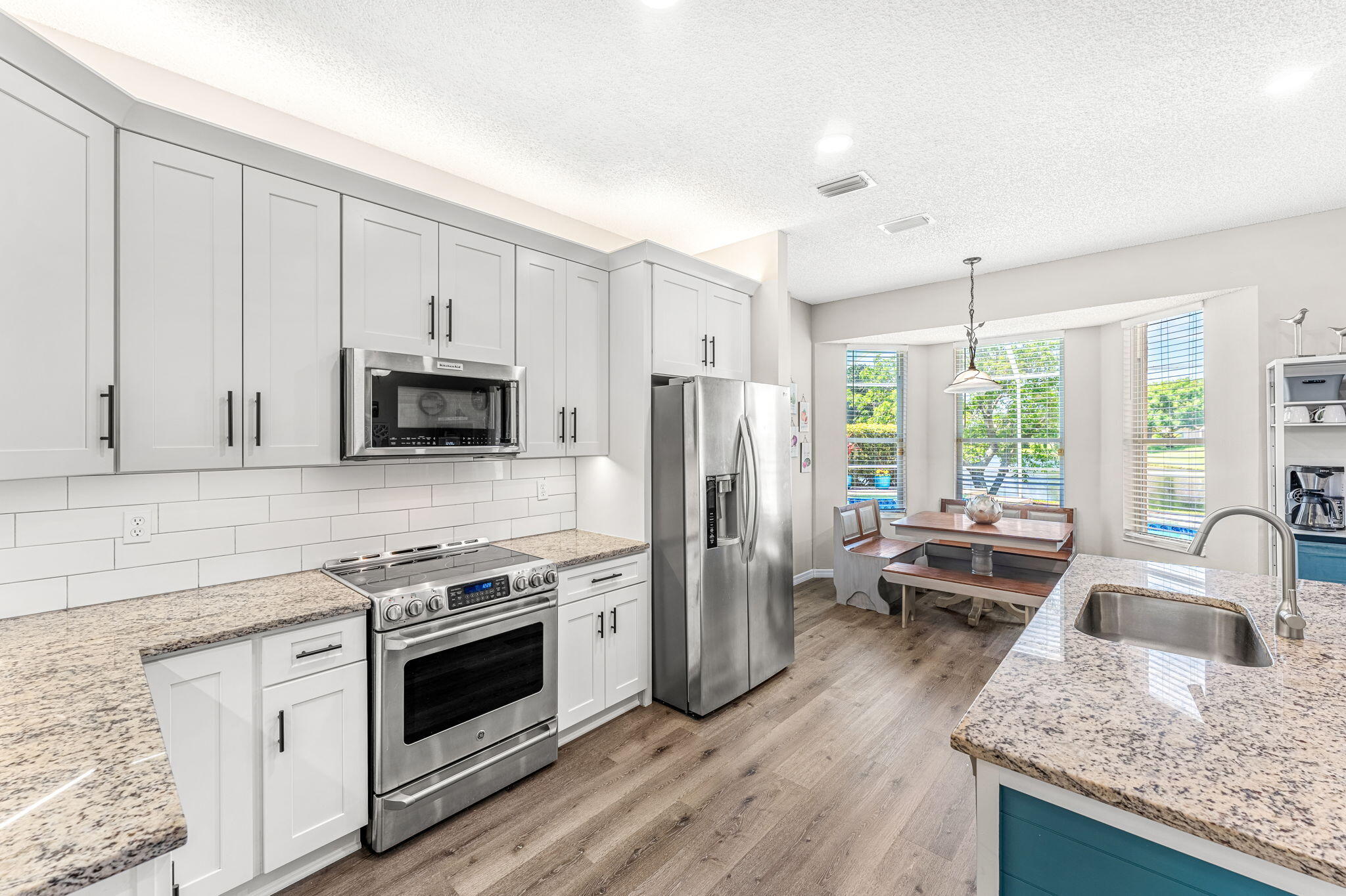 981 Shaw Circle Melbourne, FL 32940 - Photo 7 of 58 a kitchen with a sink stove and refrigerator