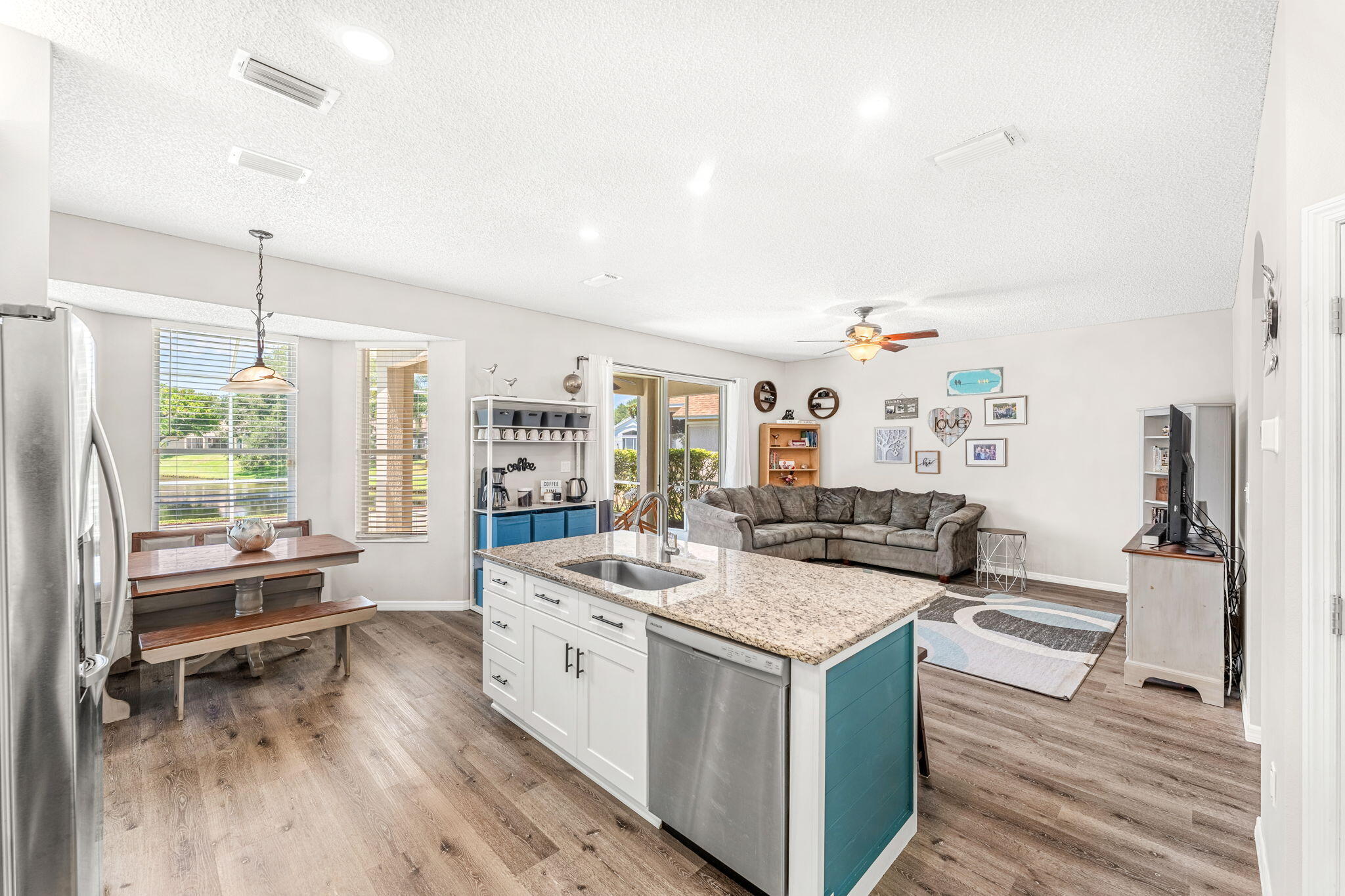 981 Shaw Circle Melbourne, FL 32940 - Photo 9 of 58 a open kitchen with stainless steel appliances granite countertop a lot of counter space and wooden floors