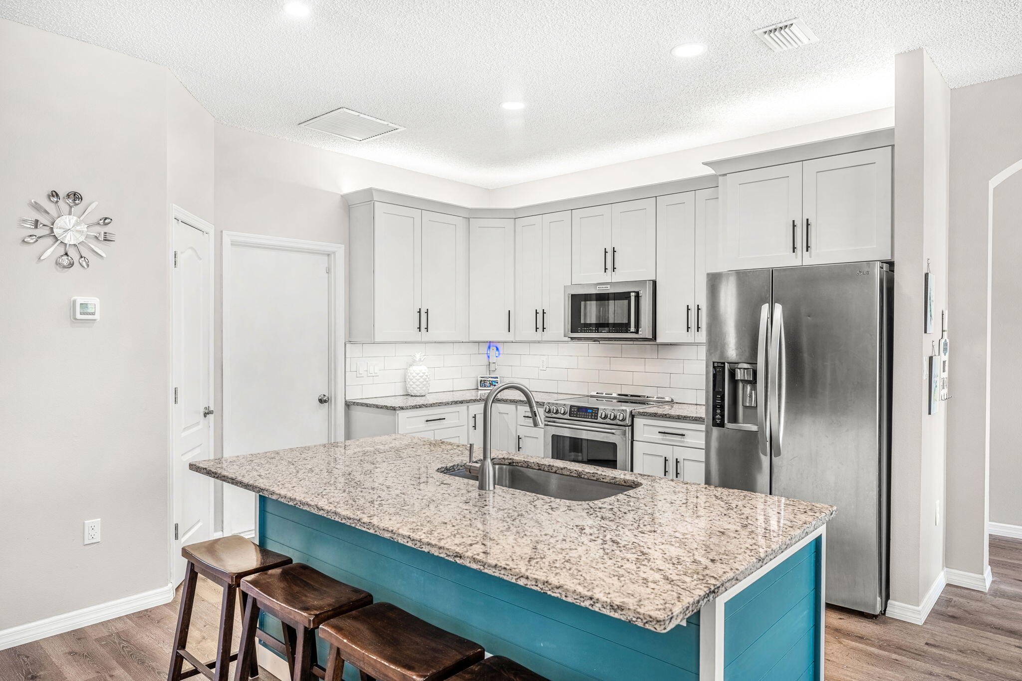 981 Shaw Circle Melbourne, FL 32940 - Photo 10 of 58 a kitchen with stainless steel appliances granite countertop a kitchen island hardwood floor and wooden cabinets